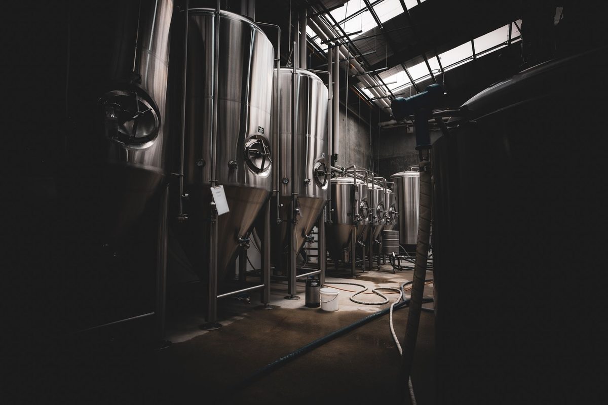 Professional craft brewery with fermentation tanks and expert beer production equipment